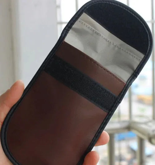 Black microfiber Faraday cage key fob bag for blocking mobile phone signals and RFID scanning