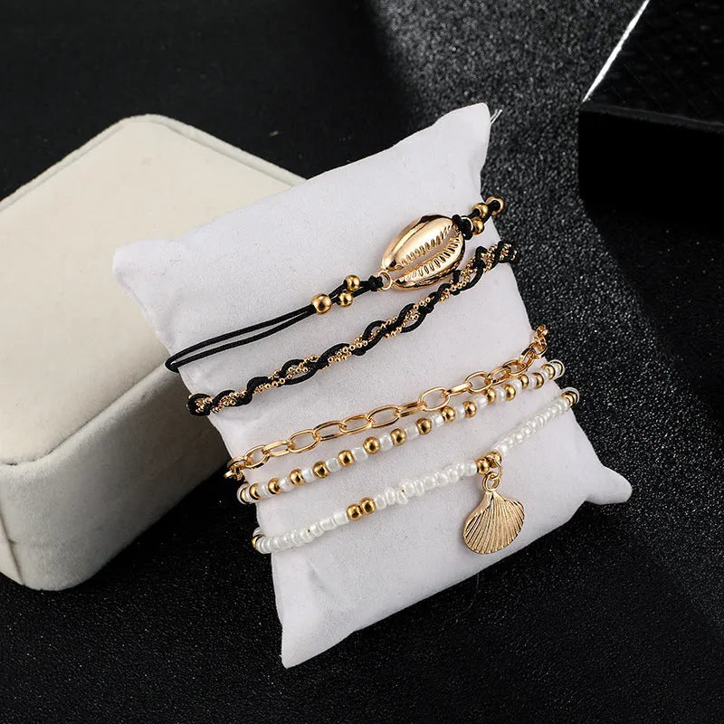 Five-piece gold tone anklet set with braided, shell and geometric ethnic style anklets for women