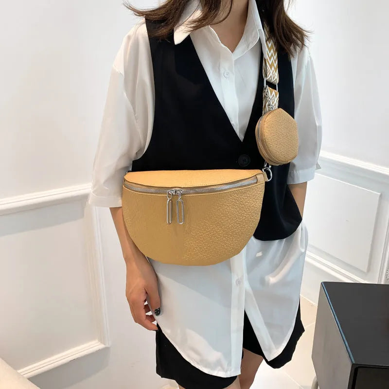 Solid colour women's crossbody bag with saddle lock zipper texture in a horizontal square clamshell shape.