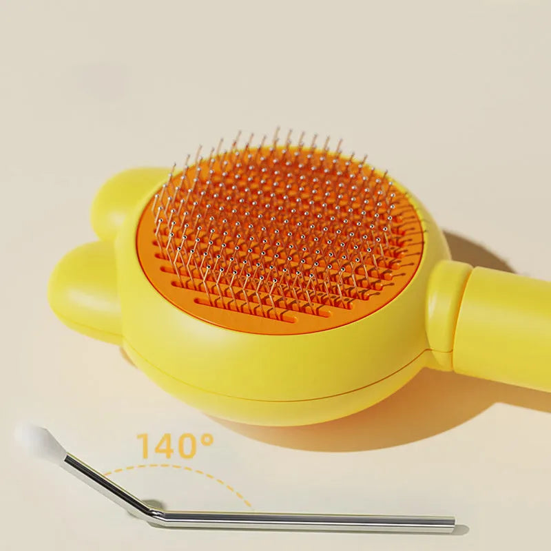 Self-cleaning pet brush with coloured comfort-grip handle and metal comb, shown with release button activated.