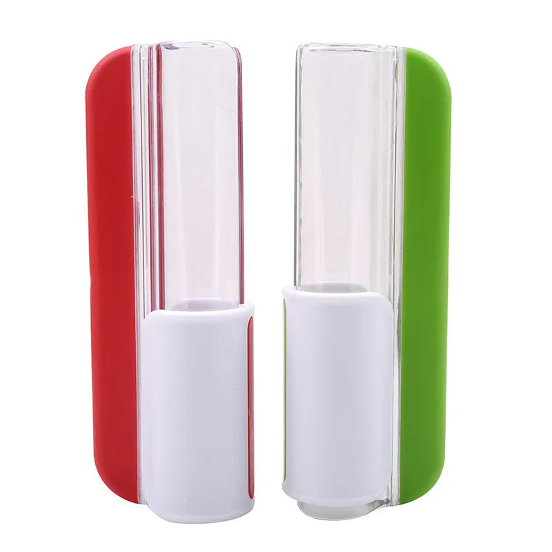 Handheld tomato and grape slicer in green with concealed stainless steel blade on a white background