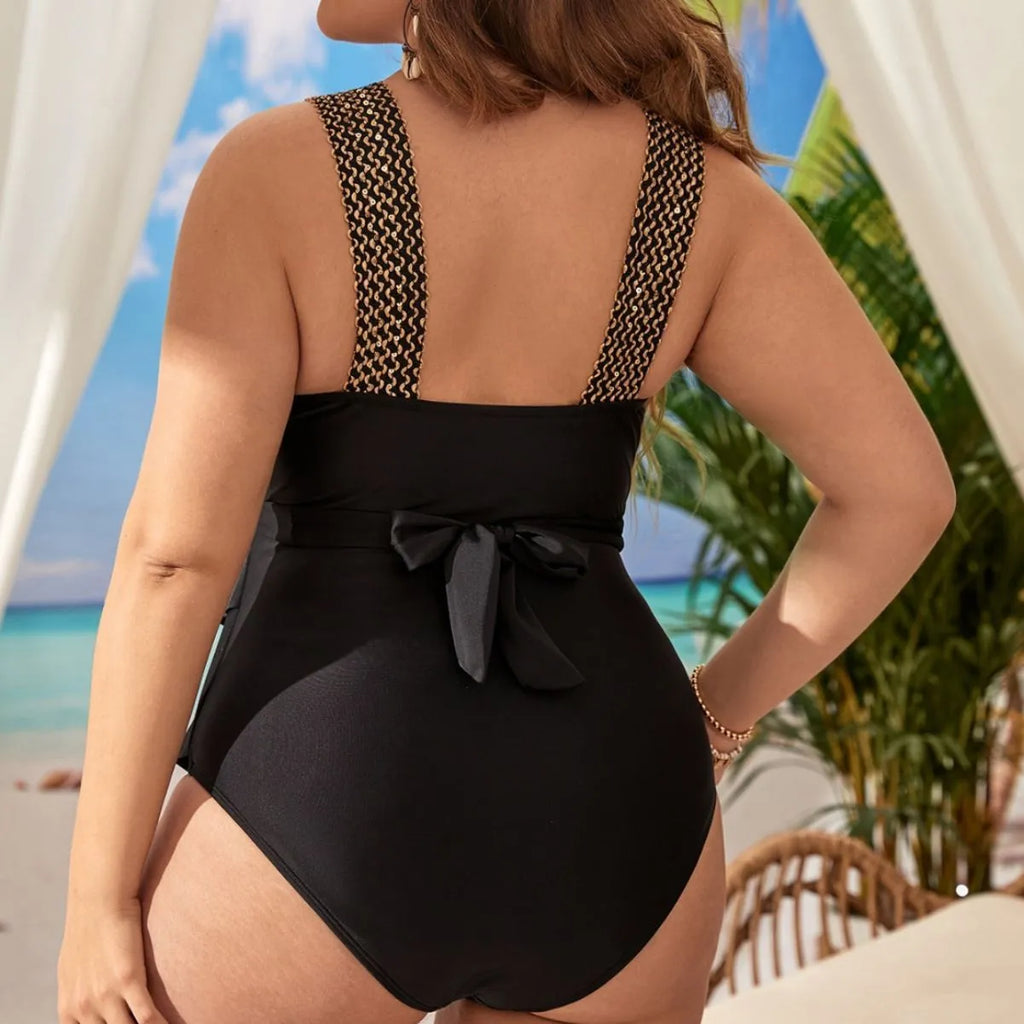 Women's black plus-size one-piece swimsuit with a chest pad on a mannequin