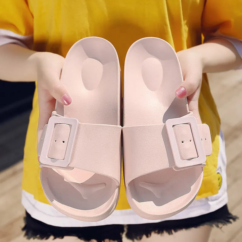 Women's grey blue flip-flop slippers with a buckle strap and soft EVA sole on a light background.