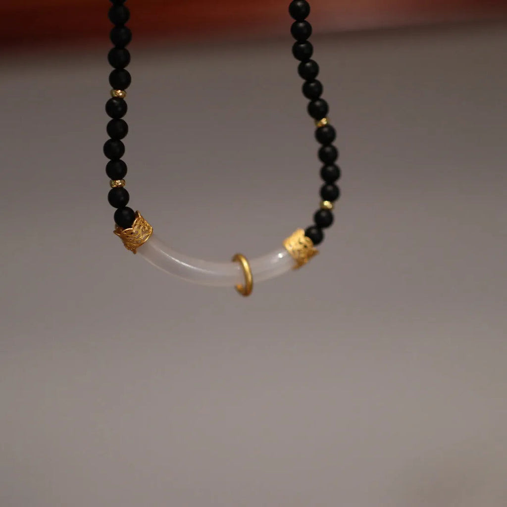 Natural frosted black agate and white chalcedony necklace with silver pendant on ball bead chain.