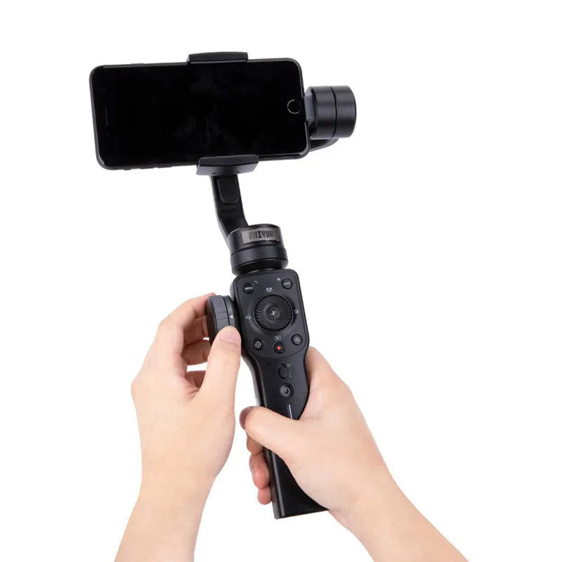 Black ABS plastic handheld smartphone video stabiliser gimbal on a table.