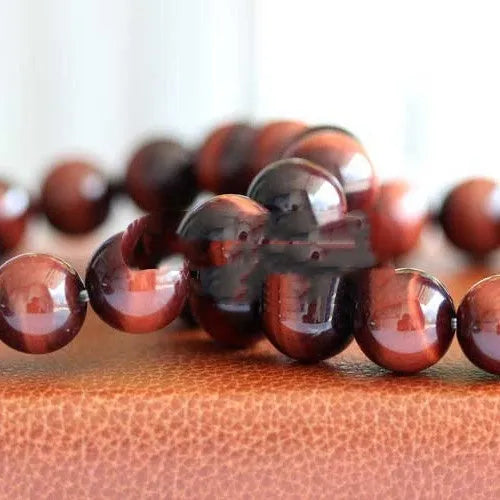 Wooden Tigereye bracelet with Lightning Cat's Eye design on wrist, showing geometric round beads.