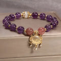 Close-up of a handmade copper bracelet for women with a drop-shaped longevity lock charm, Ruyi element, amethyst stones, and gold accents.