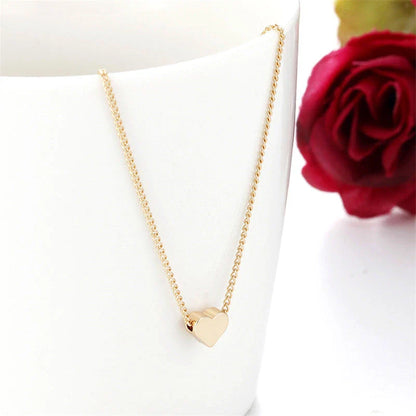 Elegant gold-tone double-sided love pendant necklace with clavicle chain, a versatile accessory for any outfit