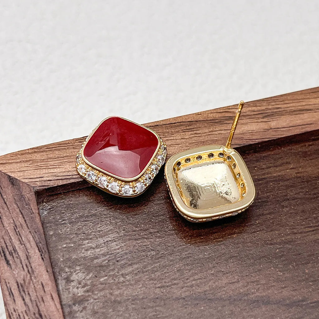 A pair of retro red square geometric alloy earrings with an inlaid design detail.