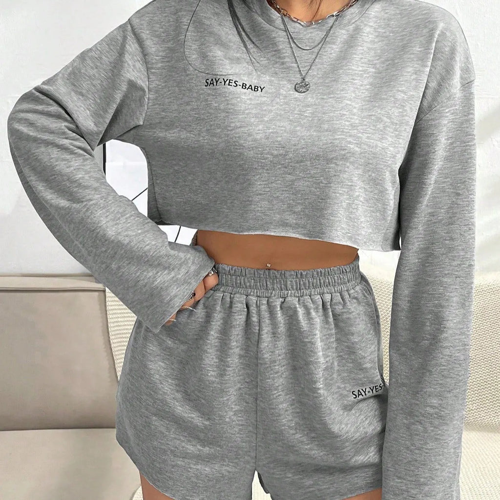 Grey women's long-sleeved T-shirt and matching shorts lounge set laid flat