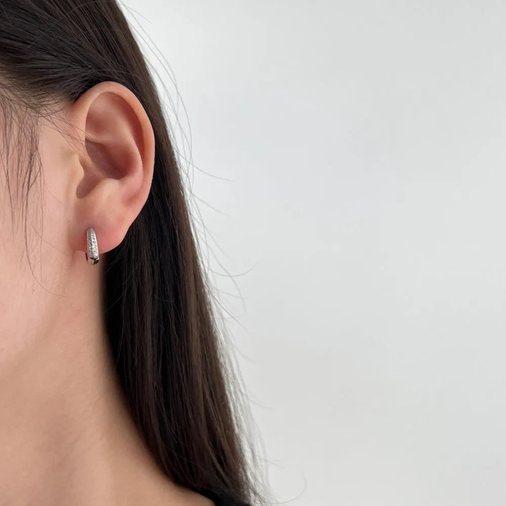 Round zircon gang drill stud earrings in 925 silver with gold electroplated finish on white background