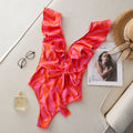 Women's one-piece swimsuit with double-shoulder ruffles, deep V-neck mesh stitching, and printed pattern.