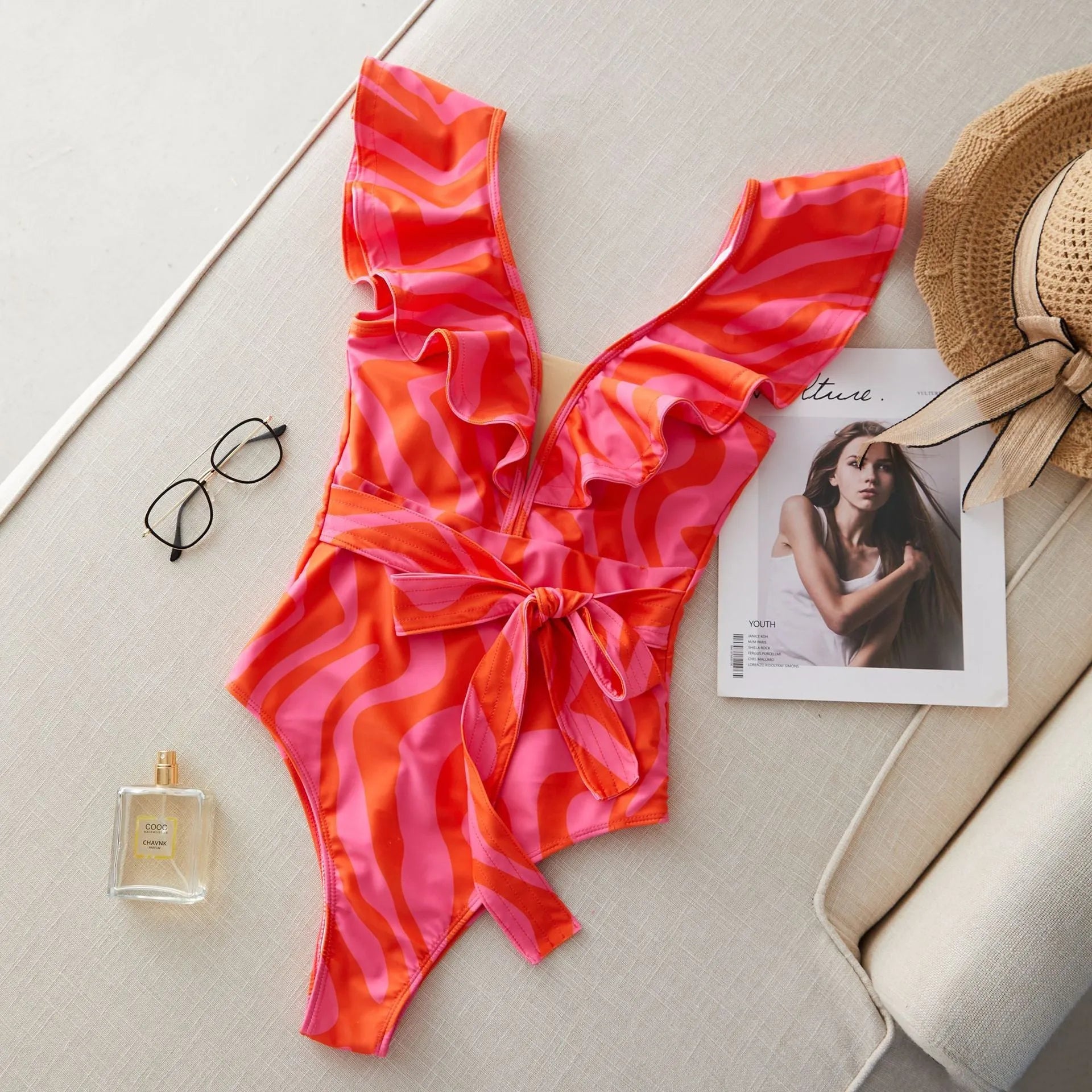 Women's one-piece swimsuit with double-shoulder ruffles, deep V-neck mesh stitching, and printed pattern.