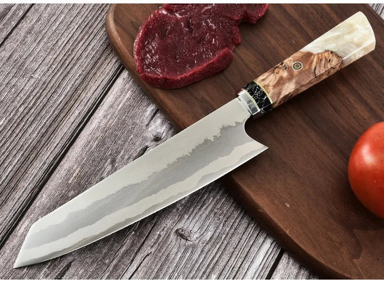 Stainless steel chef knife with 440C blade and turquoise resin handle on cutting board