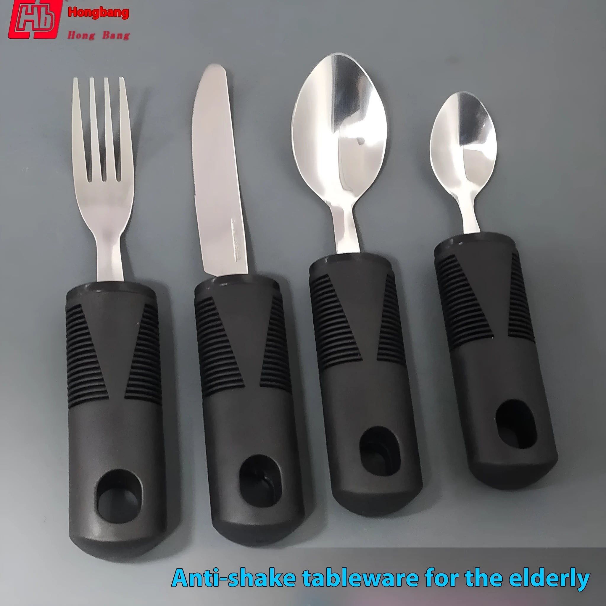 Stainless steel adaptive cutlery with curved rubber handles for tremor support in black and grey options