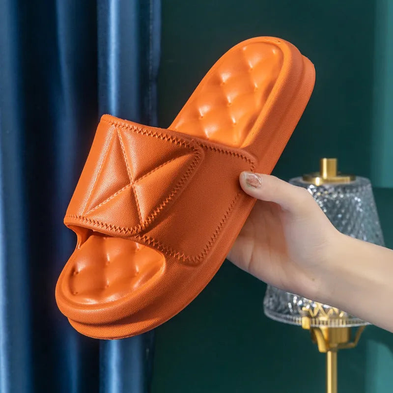 A pair of thick-soled EVA bathroom slippers in a choice of colours, showing non-slip sole texture.