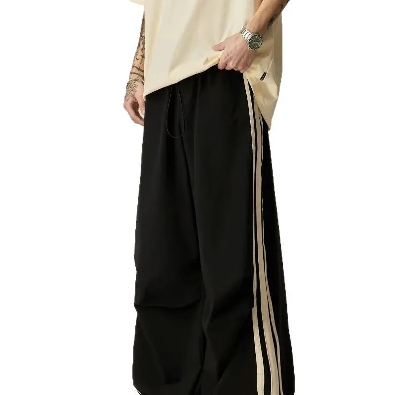 Men's black high-waist wide-leg climbing trousers with straight leg on a plain background.