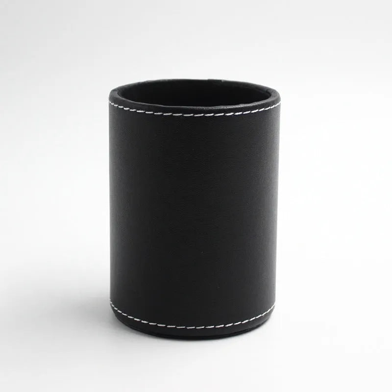 Round black leather pen holder with 8.0cm diameter on desk