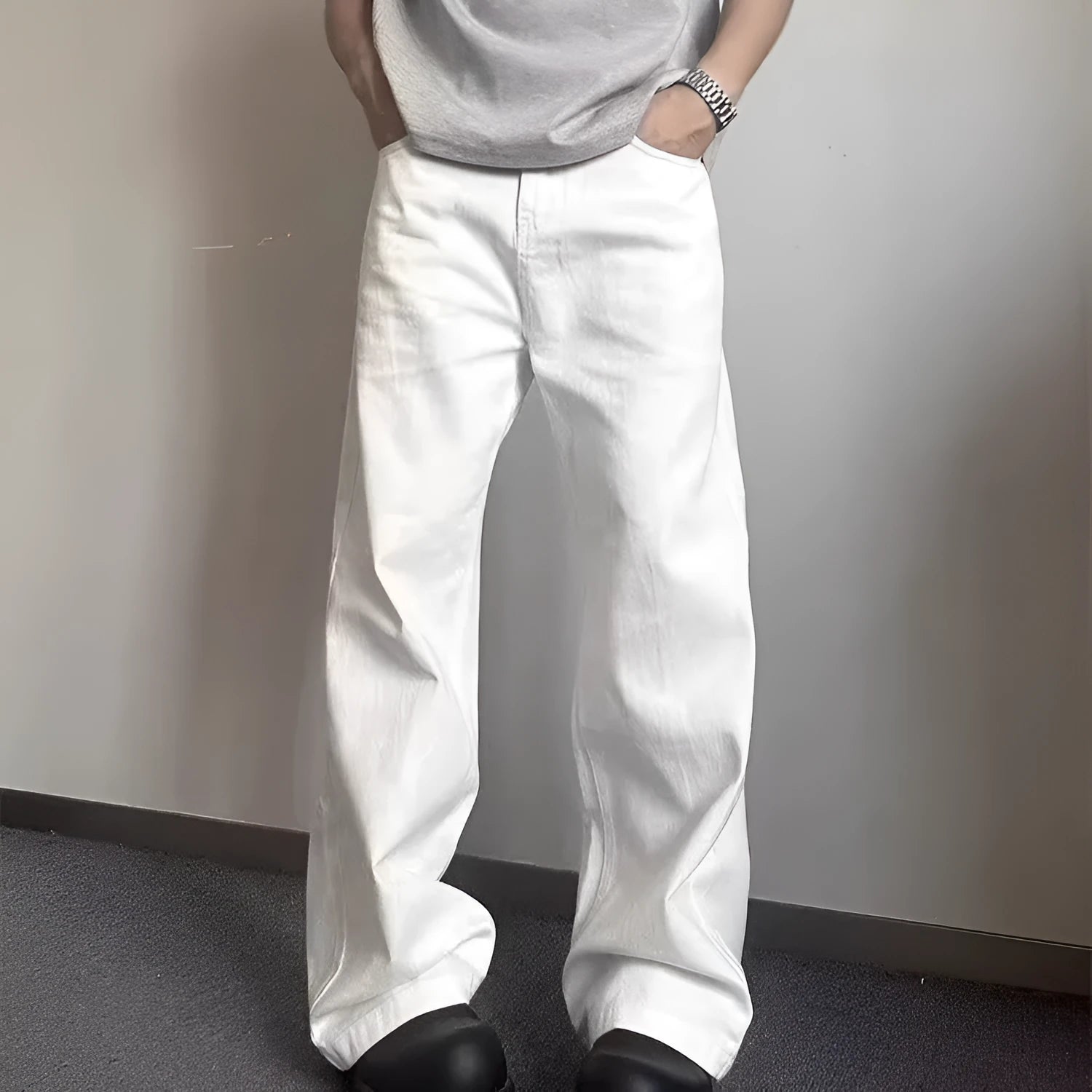 Men's white straight-leg cotton jeans with a wide-leg opening and zipper fly.