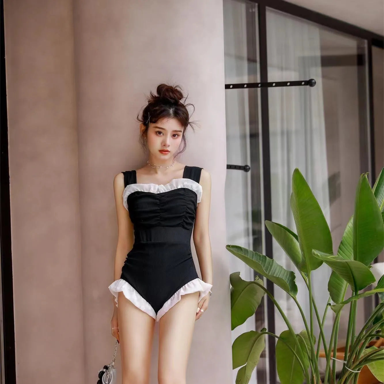 Korean style triangle top one-piece swimsuit for women with high waist in black colour.