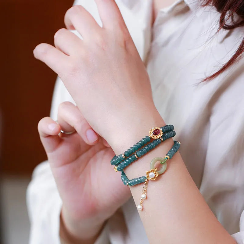 Blue water jade abacus bead and tourmaline bracelet on three sterling silver rings for women.