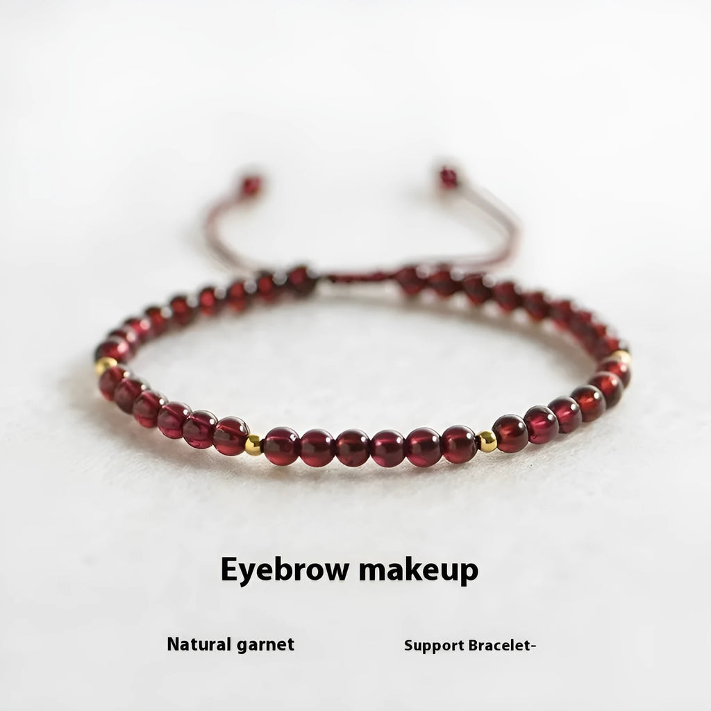 Hand-woven garnet bracelet with red rope and flexible wire construction showing national tide style