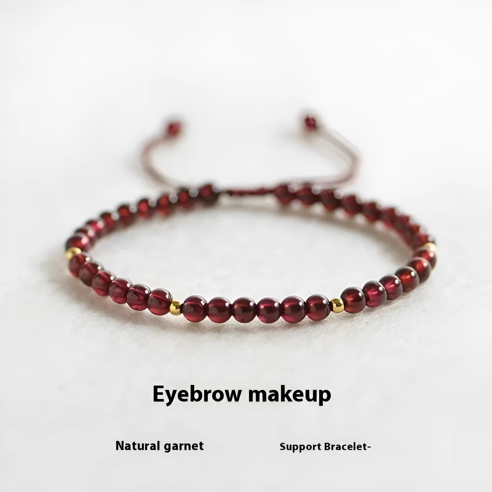 Hand-woven garnet bracelet with red rope and flexible wire construction showing national tide style