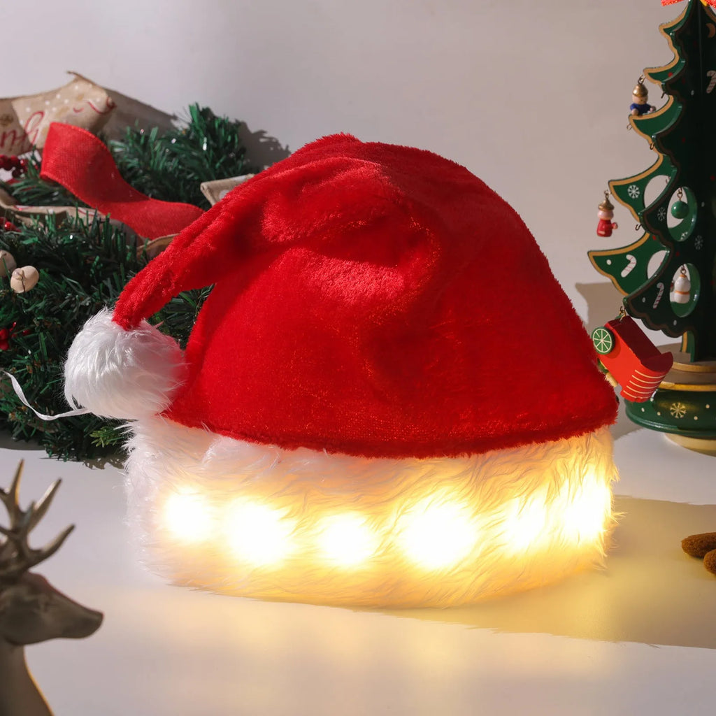 Red and white plush Santa hat with glowing LED lights and a white pom-pom, shown on a person's head.