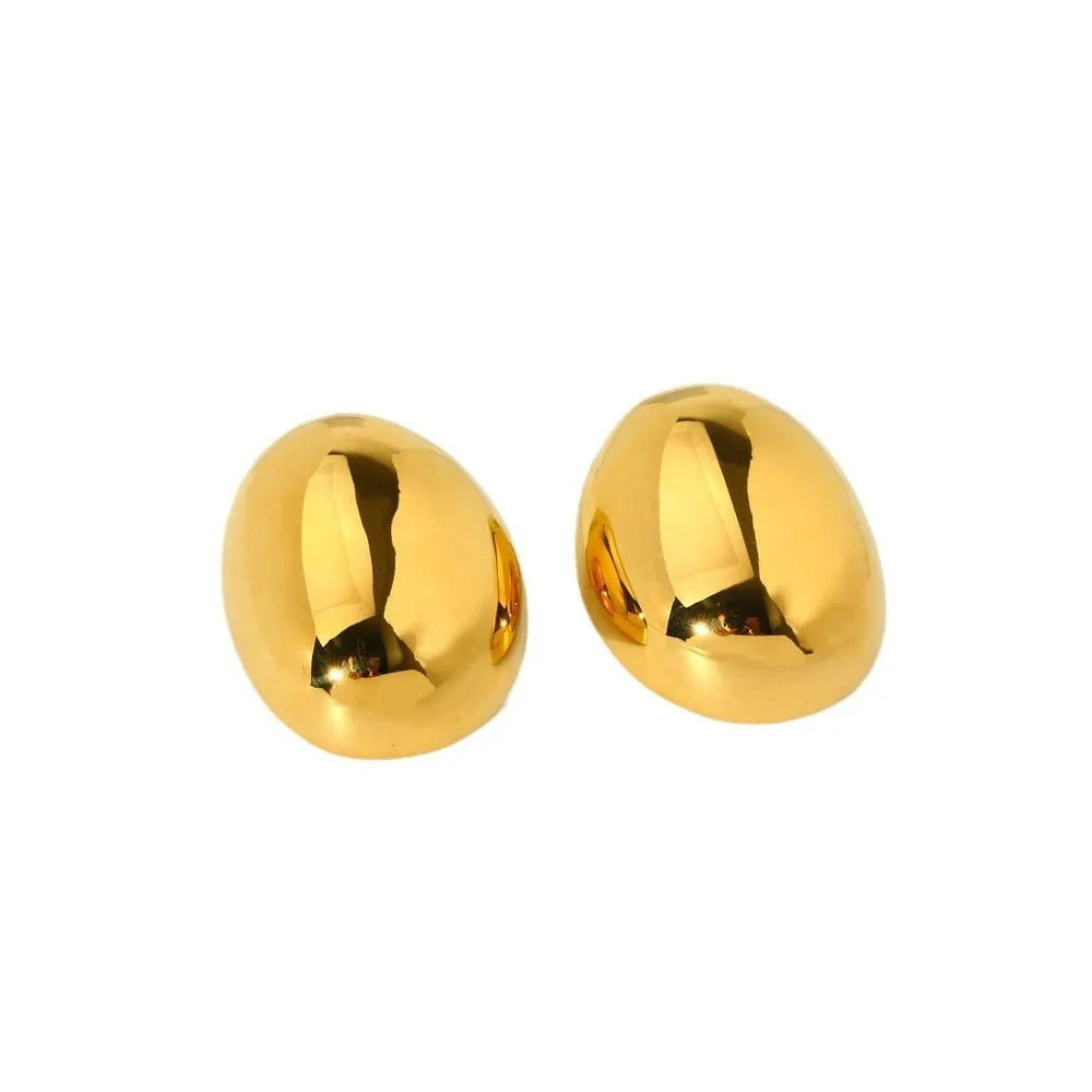 Geometric stainless steel ear studs with a gold electroplated finish and exaggerated glazed surface.