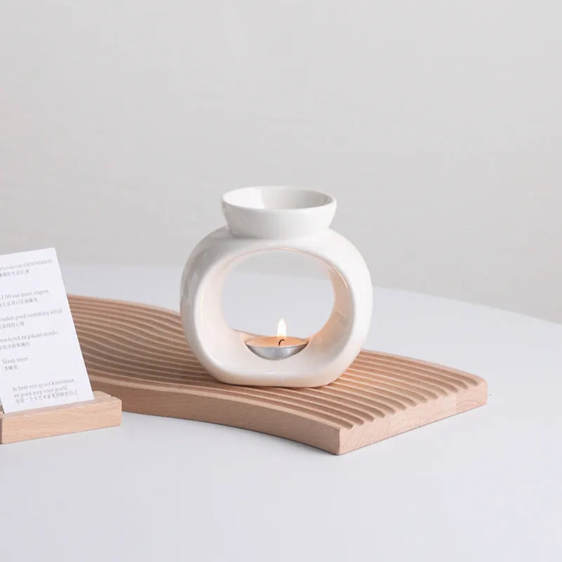 White glazed porcelain Nordic style aromatherapy stove ornament on a table.