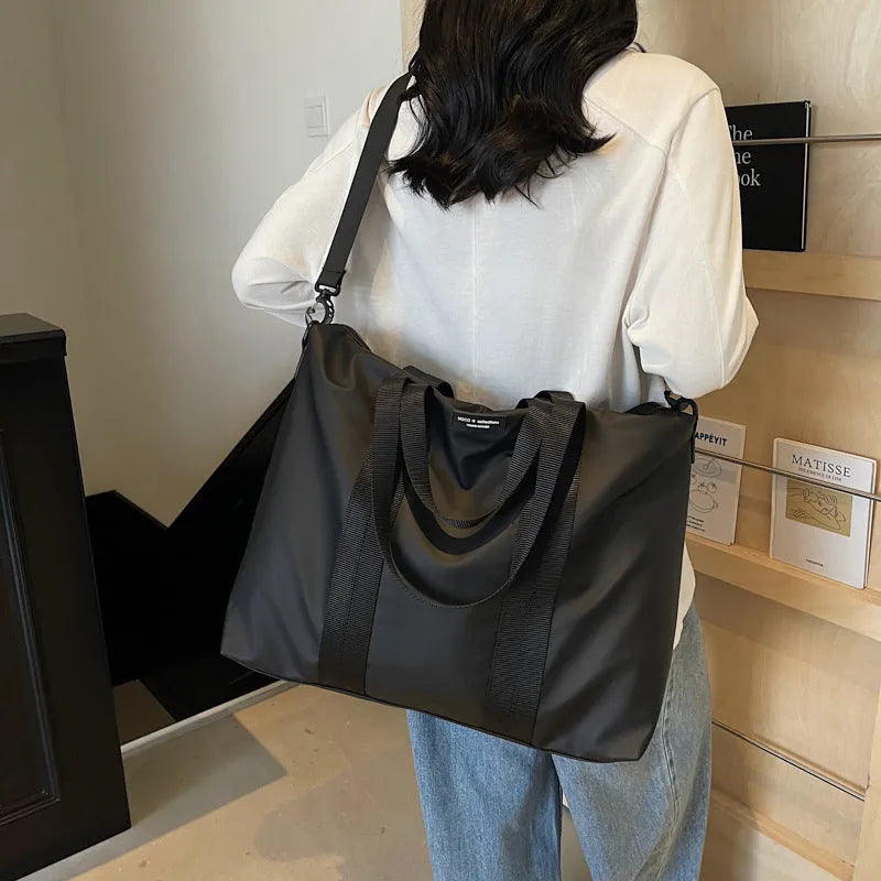 Lightweight Oxford cloth tote bag in black colour with 20-35L capacity for travel storage
