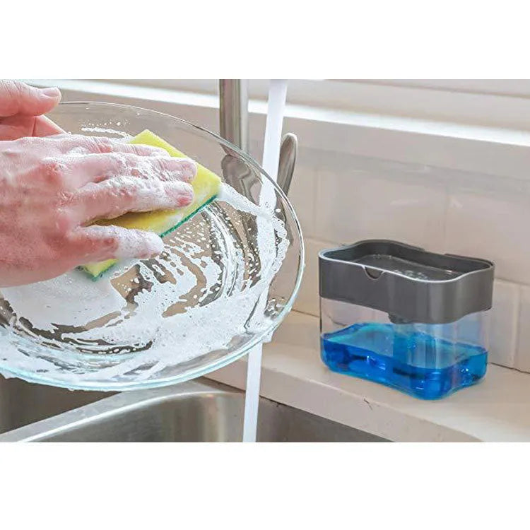 A grey automatic touch-free soap dispenser for the kitchen on a worktop.