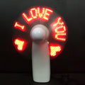 White handheld mini fan with blue and red LED 'I love you' flashing pattern on display.