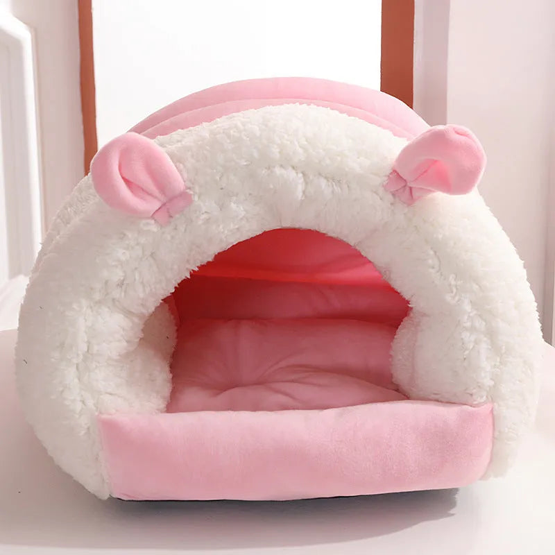 Blue enclosed cat bed with removable fleece liner, shown in a home setting.