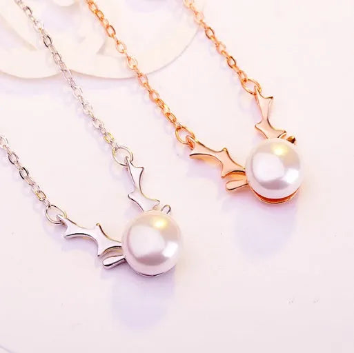 Small elk pearl pendant in copper with gold finish, front view against white background
