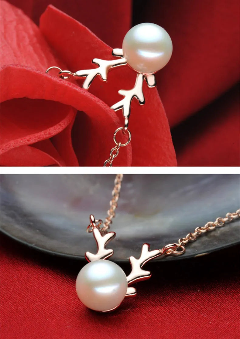 Small elk pearl pendant in copper with gold finish, front view against white background