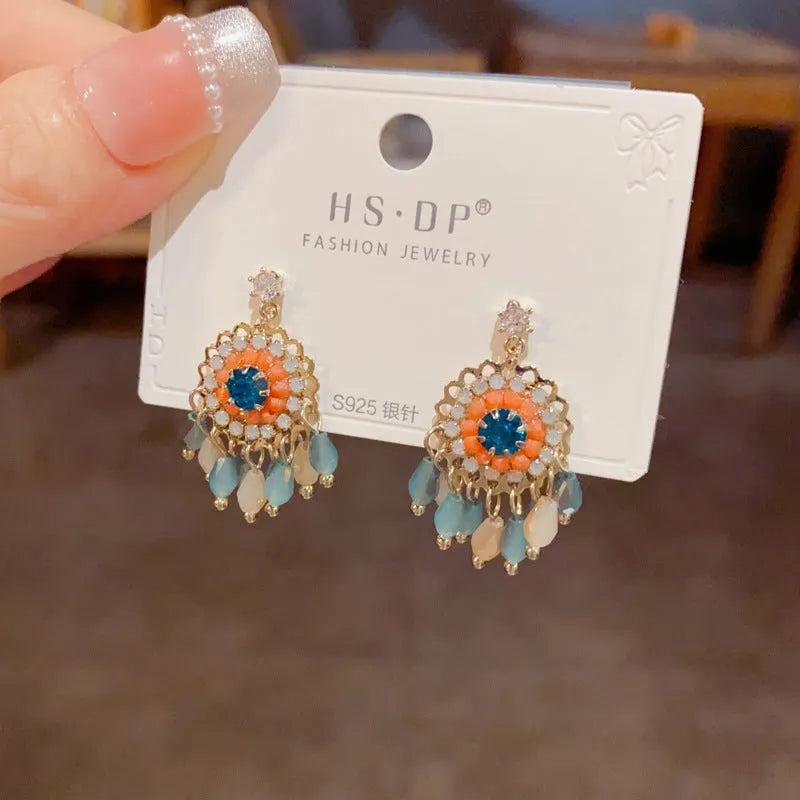 Geometric crystal tassel drop earrings with diamond embedded stones and thick gold plating
