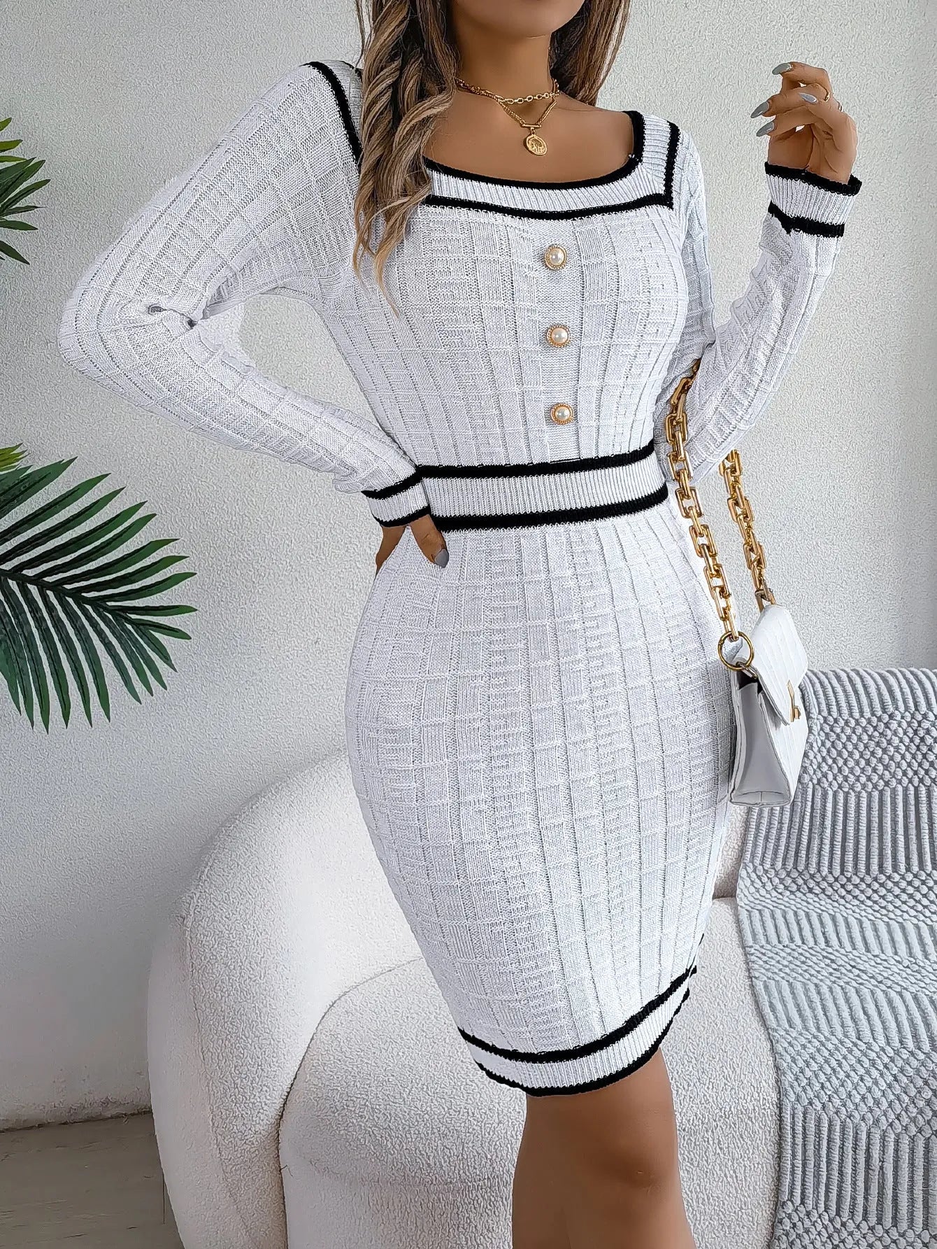 Women's long-sleeved organic cotton sweater dress with lantern sleeves and an A-line hip skirt.