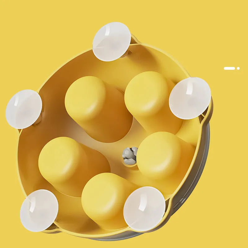 Bright yellow interactive cat toy and snack bowl for pet entertainment and feeding.