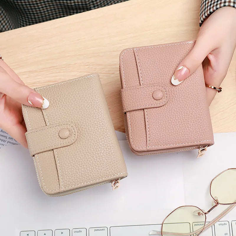 Ladies' short beige wallet with a lychee fruit pattern, shown folded.