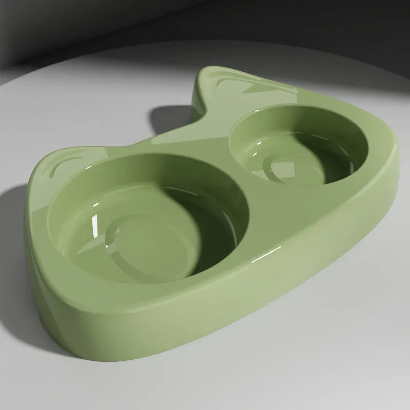 Two-in-one stainless steel slow feed cat bowl with large and small eye compartments, anti-choking design, in blush pink