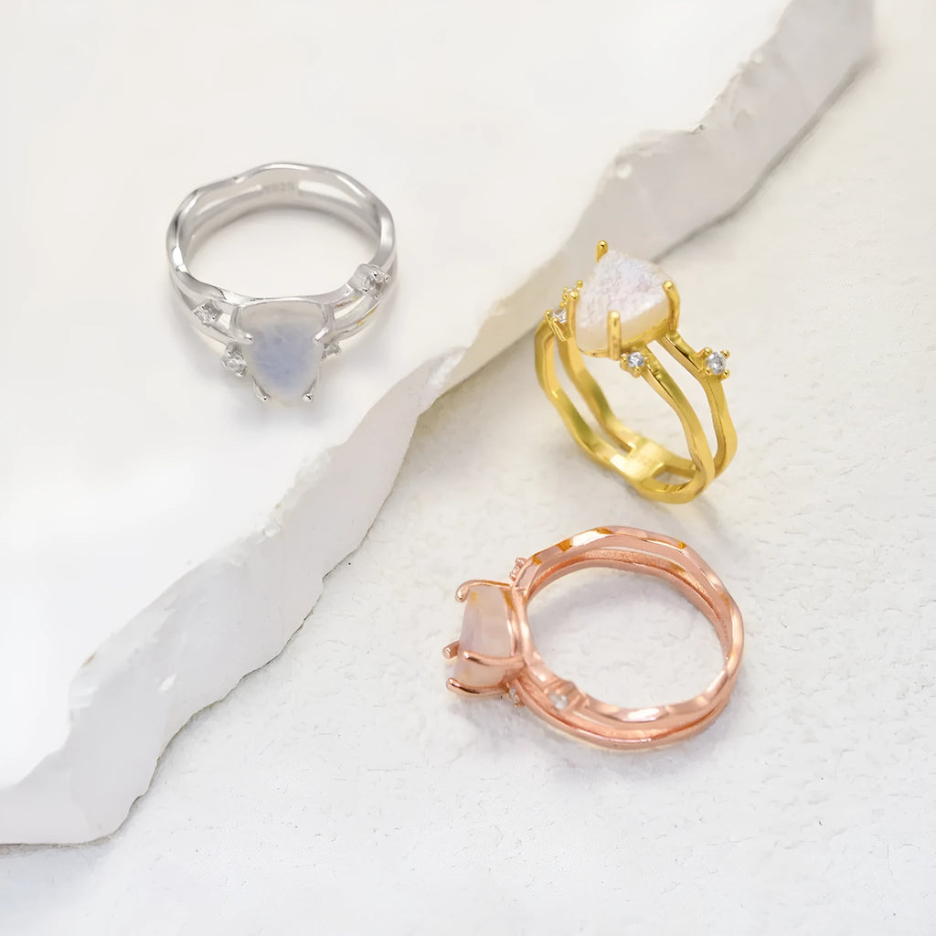 S925 silver irregular triangle ring with a moonstone, shown in rose gold, white gold, and yellow gold finishes.