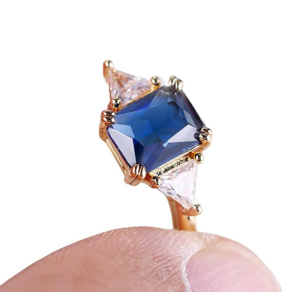 Rectangular copper ring with gold sapphire blue finish for women, shown in size options 6 to 13