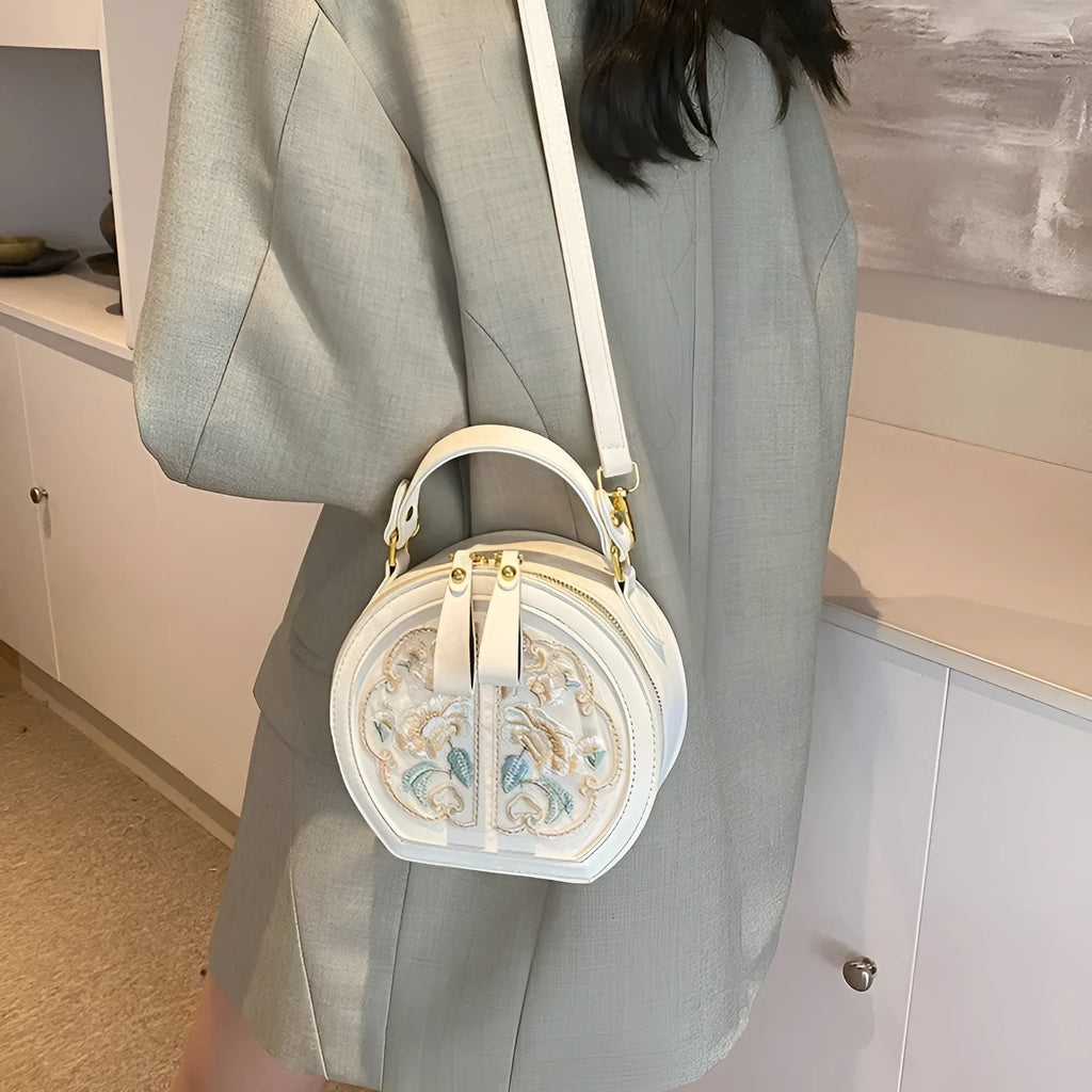 Soft PU Chinese embroidery messenger bag in horizontal square shape with adjustable shoulder strap.