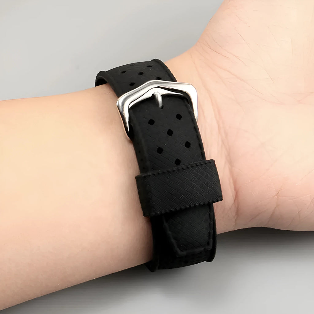 Black silicone watch strap with raised mouth and silver pin buckle on a smart watch