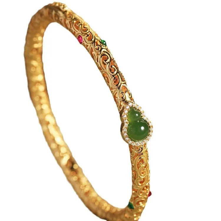 Gold-plated women's open cuff bracelet with xiangyun gourd charm on copper electroplated construction