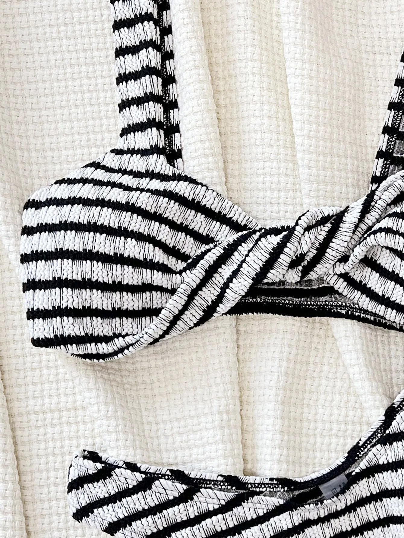 Women's black and white contrast colour bikini set with polyester fabric, slim brief cut, and bra and shorts