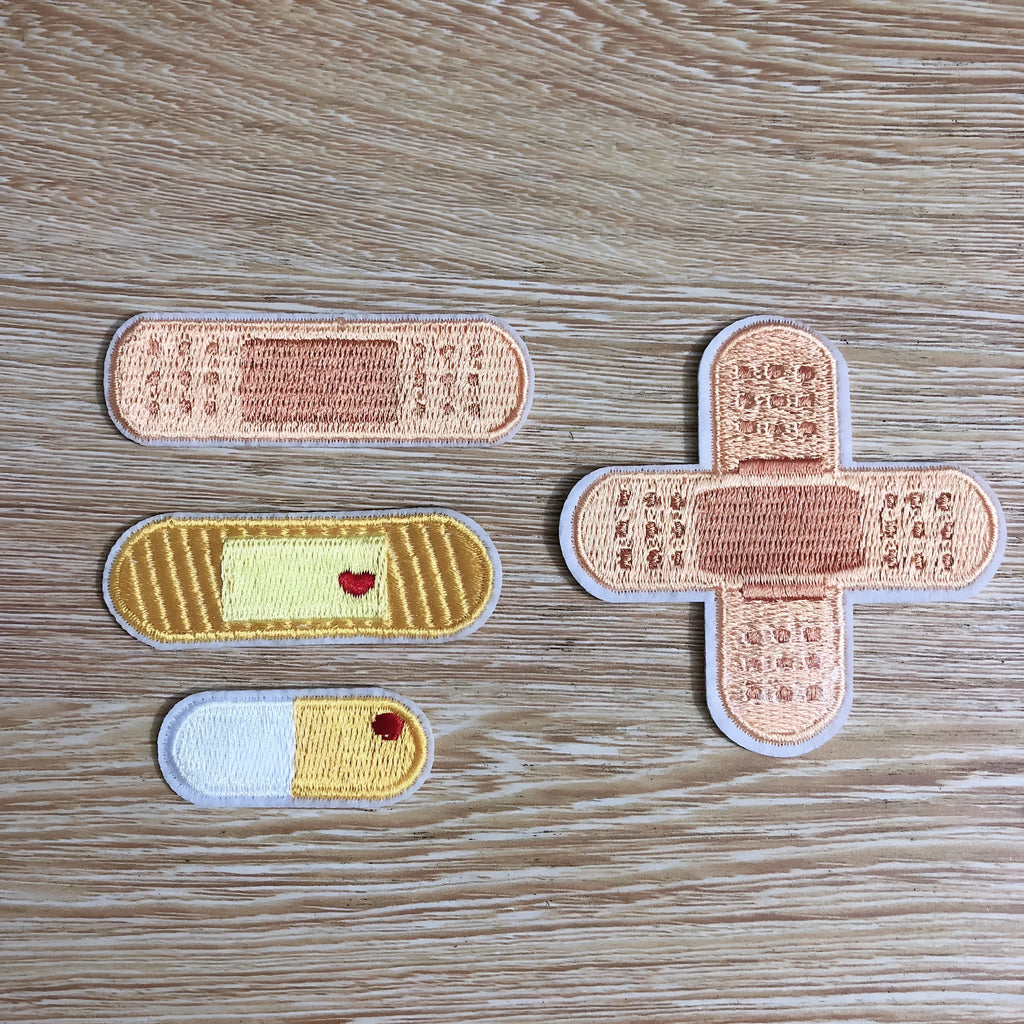 Pack of ten embroidered cloth patch badges in various designs for DIY clothing customisation.