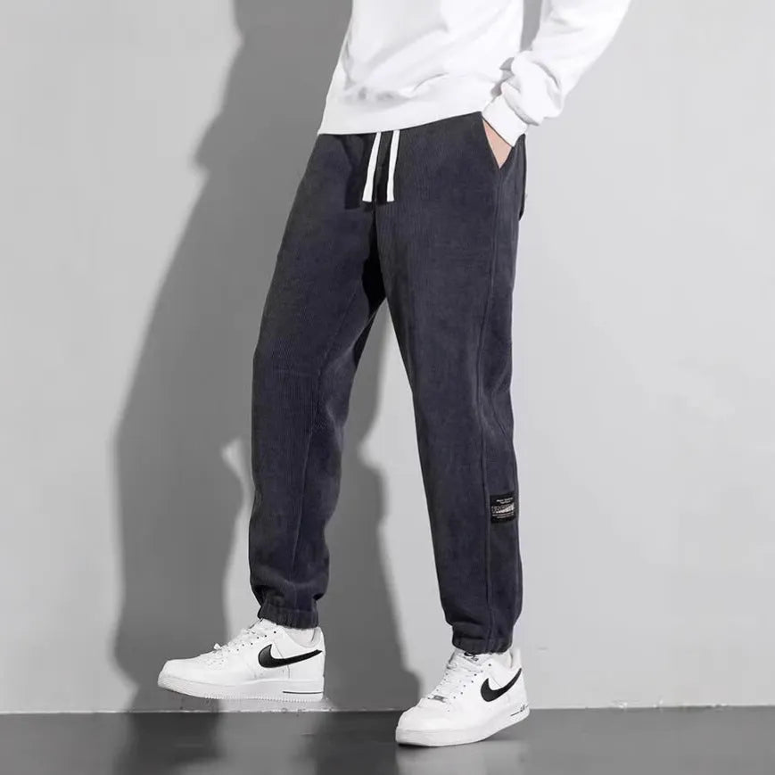 Men's loose straight drapey sweatpants in dark gray with drawstring waist and cotton blend fabric