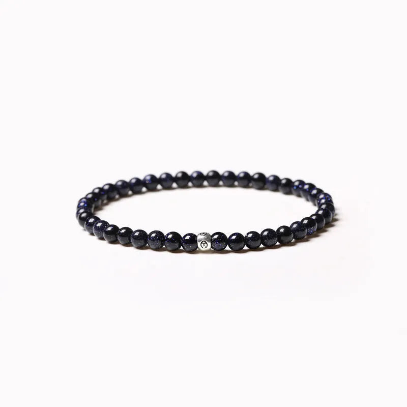 Simple geometric agate bracelet with round and square 4mm beads on a wrist.